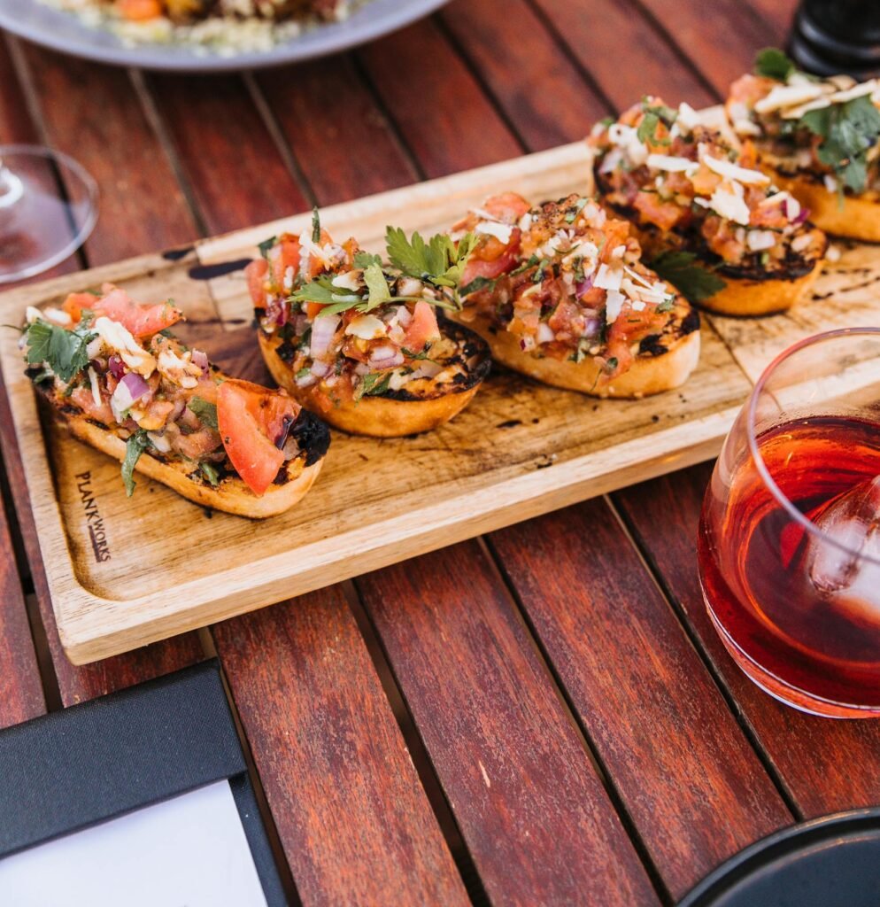 Close-up of Italian bruschetta served on a wooden tray, perfect for food enthusiasts.