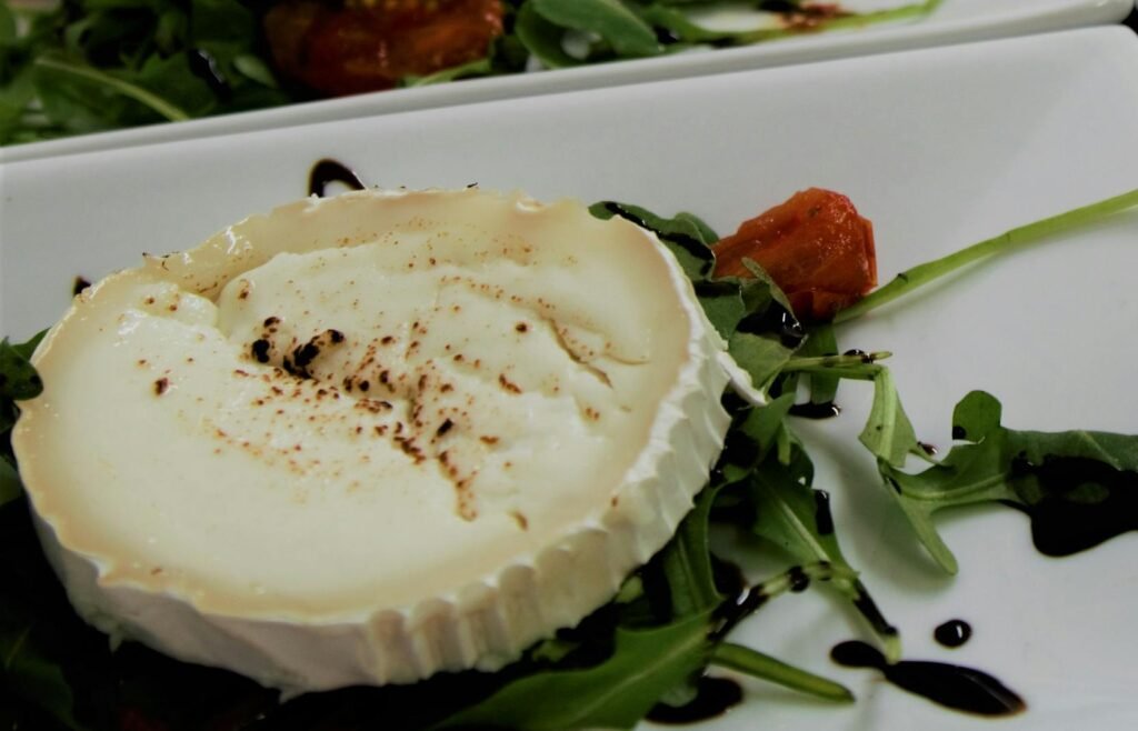 Plates of goat cheese with arugula and balsamic reduction, perfect for appetizers or a light meal.