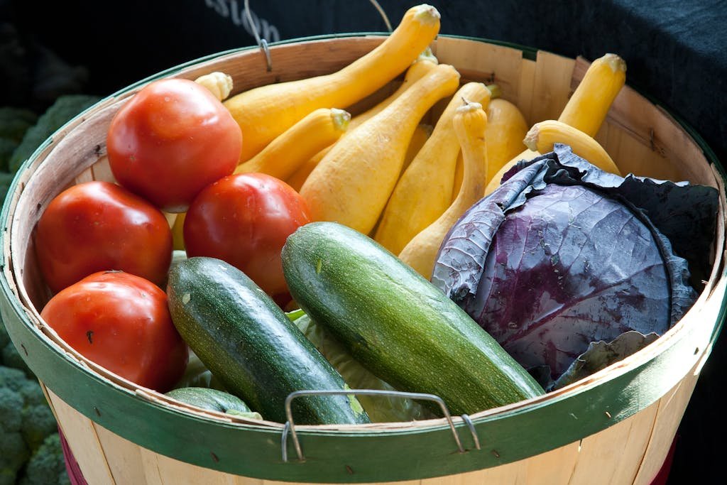 Vibrant assortment of fresh vegetables in a basket, highlighting healthy and organic produce.