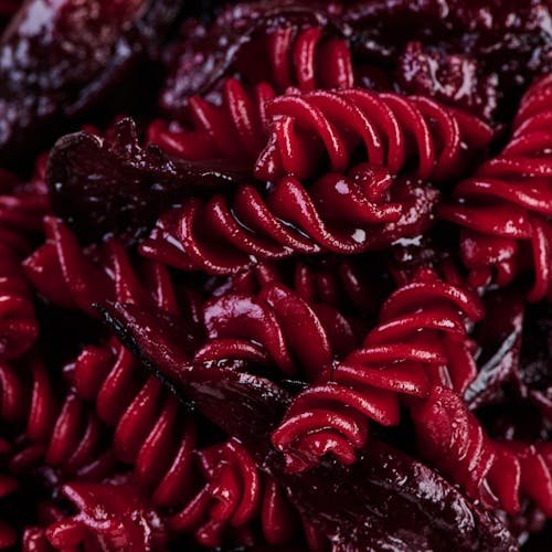 Close-up of vibrant red beet pasta highlighting its rich texture and color. Perfect for culinary enthusiasts.